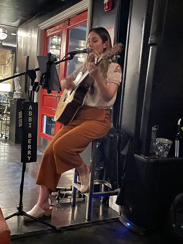 Abbi Berry playing guitar at the Maison 140 Hotel in Beverly Hills, CA