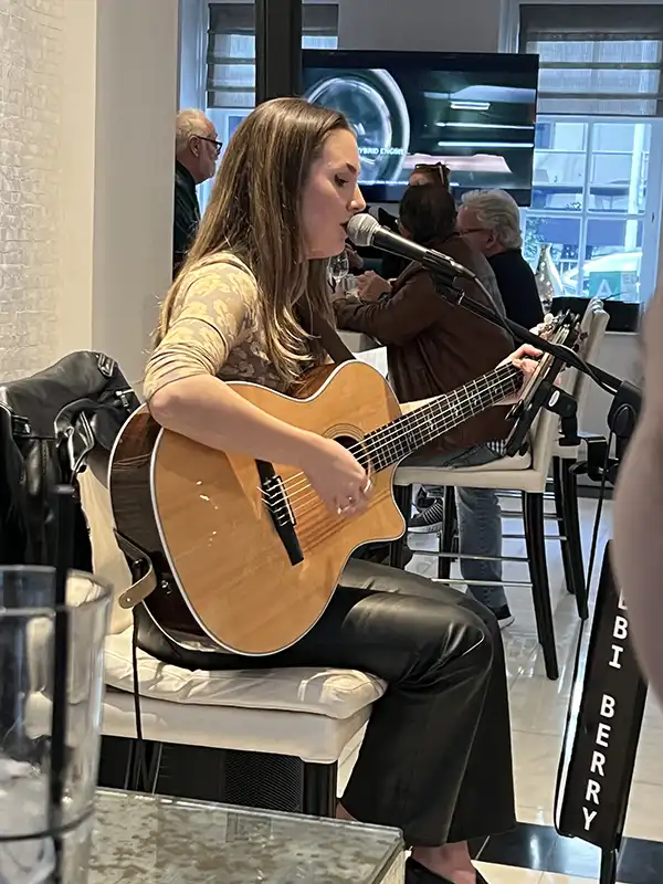 Abbi Berry playing guitar at the Mosaic Hotel in Beverly Hills, CA