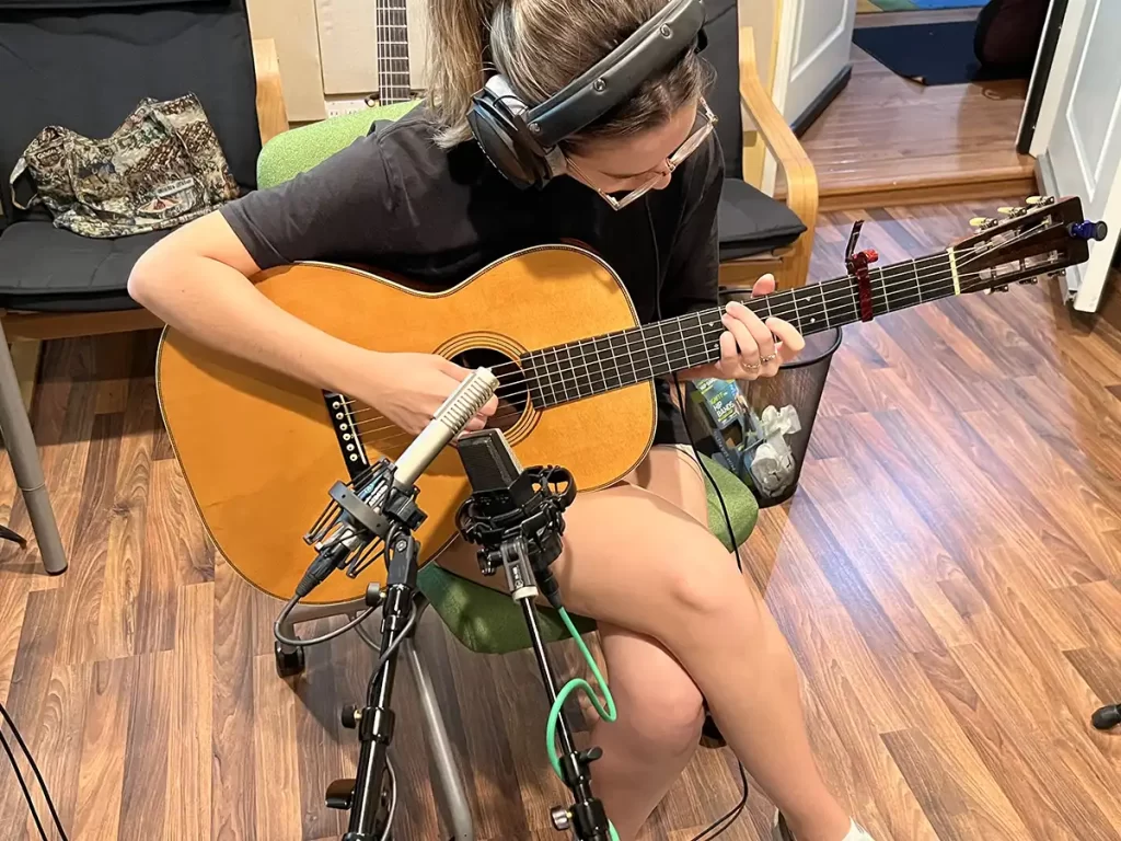 Abbi Berry recording with guitar